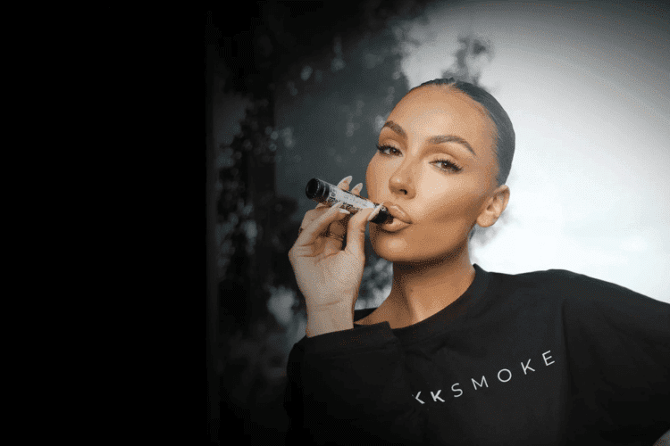 a girl in a black shirt vaping