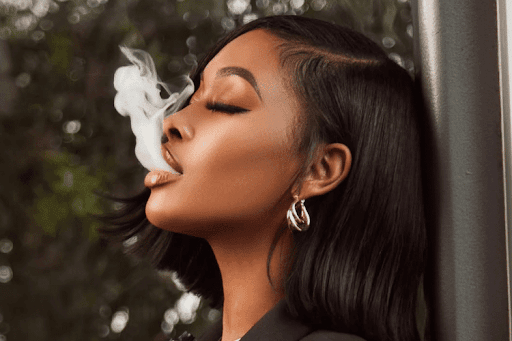 girl exhaling smoke from a vape